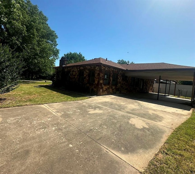 exterior space featuring a carport and a yard