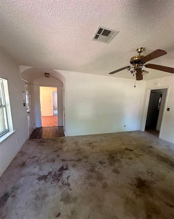 unfurnished room with a textured ceiling