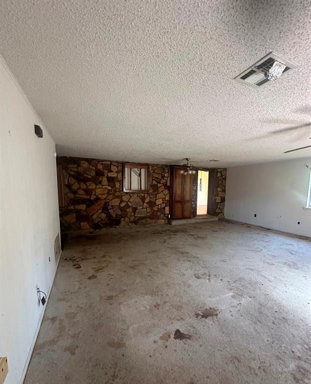 interior space with plenty of natural light and a textured ceiling