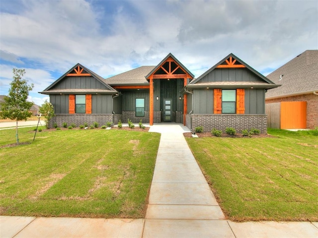 craftsman house with board and batten siding, brick siding, and a front lawn