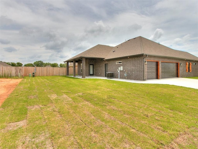 exterior space featuring a garage, central air condition unit, driveway, and fence