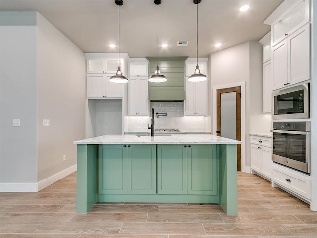 kitchen with white cabinets, wood tiled floor, oven, and built in microwave