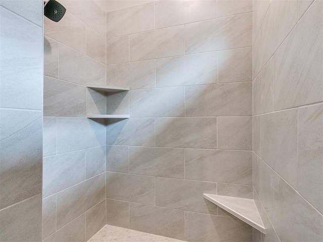 full bath featuring tiled shower