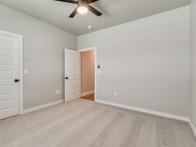 empty room featuring carpet flooring, ceiling fan, and baseboards