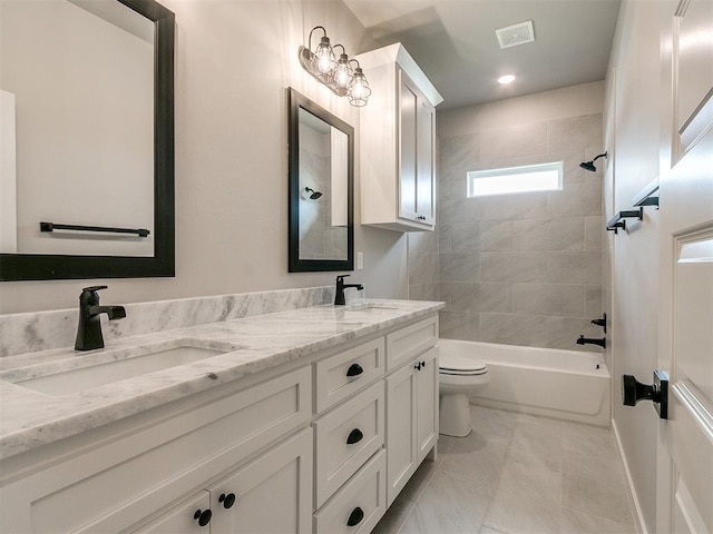 full bathroom with toilet, double vanity, visible vents, and a sink