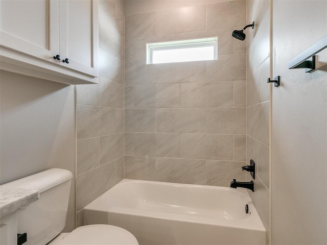 bathroom featuring shower / bathing tub combination and toilet