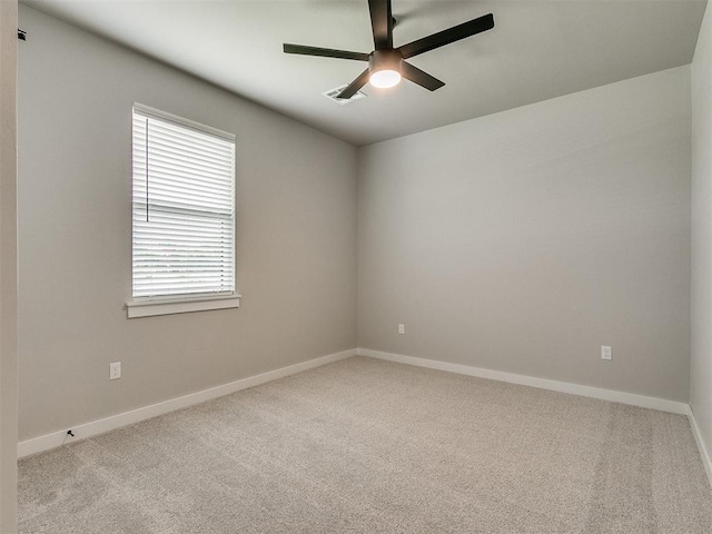 unfurnished room featuring carpet floors, baseboards, and a ceiling fan