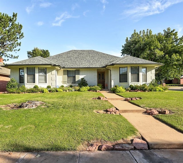 single story home featuring a front lawn