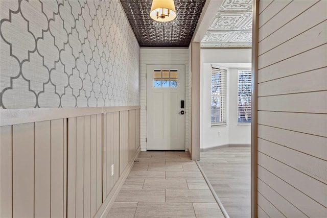 entrance foyer featuring wood walls