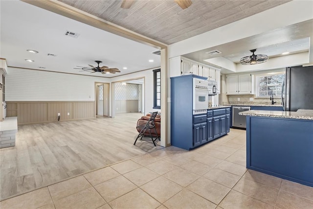 kitchen featuring blue cabinets, stainless steel appliances, white cabinetry, and ceiling fan