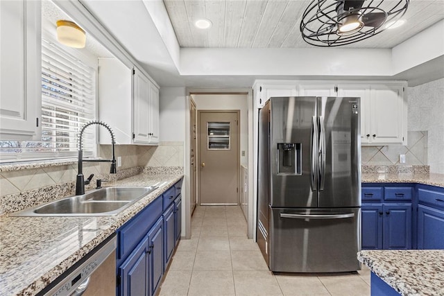 kitchen with white cabinets, appliances with stainless steel finishes, sink, and blue cabinets