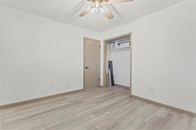 spare room with light wood-type flooring and ceiling fan