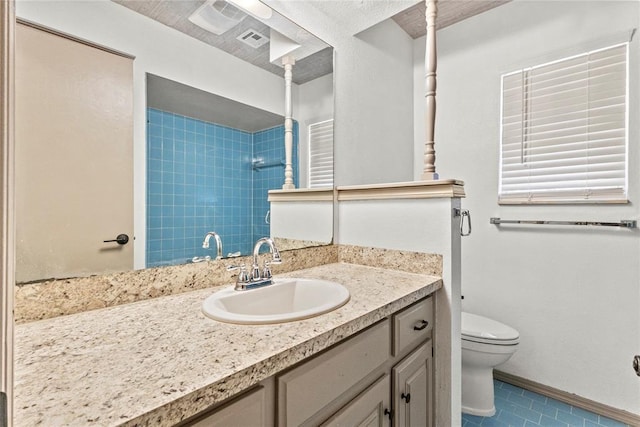 bathroom with walk in shower, toilet, tile patterned floors, and vanity