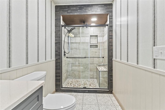 bathroom with an enclosed shower, toilet, tile patterned floors, and vanity