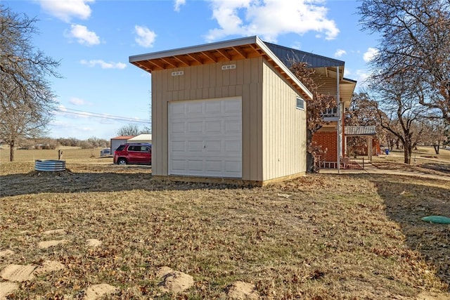 garage featuring a lawn