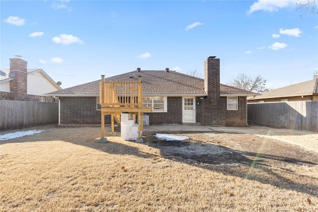 rear view of property with a patio area and a yard