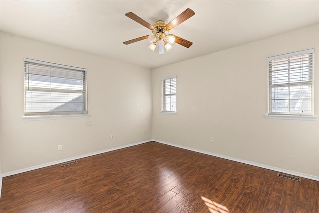 empty room featuring ceiling fan and dark hardwood / wood-style floors