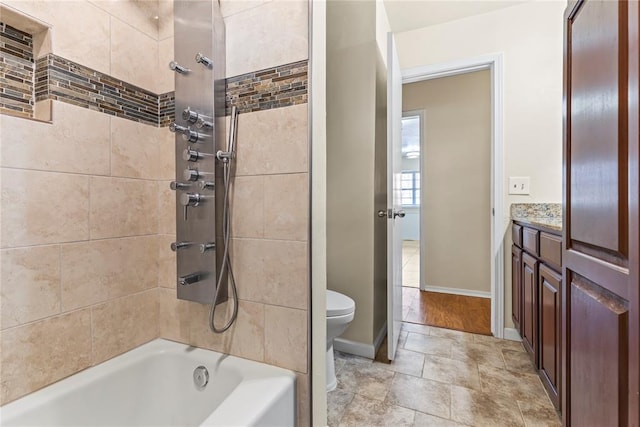 full bathroom featuring toilet, vanity, and tiled shower / bath combo