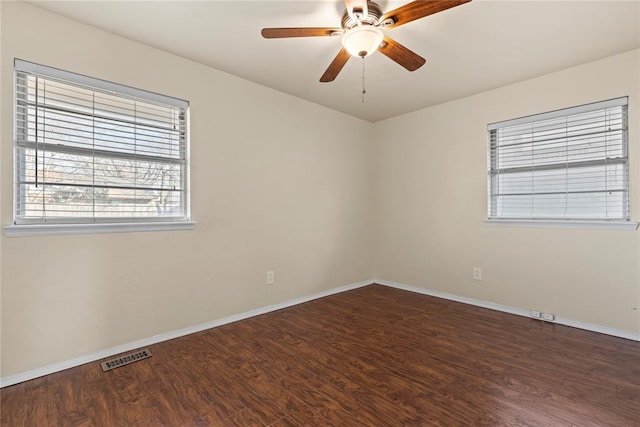 spare room with ceiling fan and dark hardwood / wood-style flooring