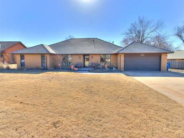 view of front of home featuring a garage and a front lawn