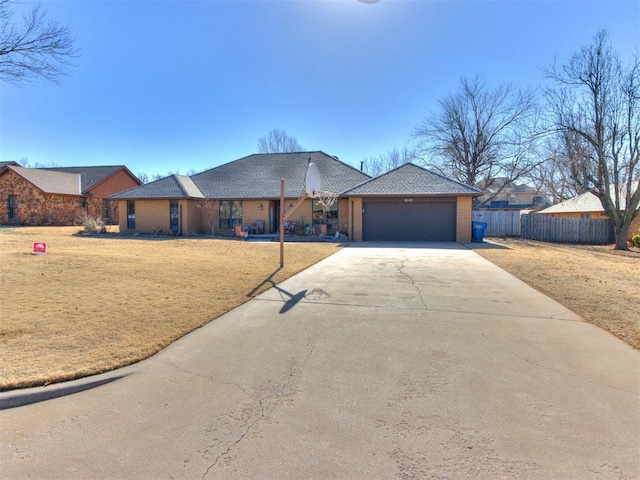 ranch-style home with a garage and a front lawn