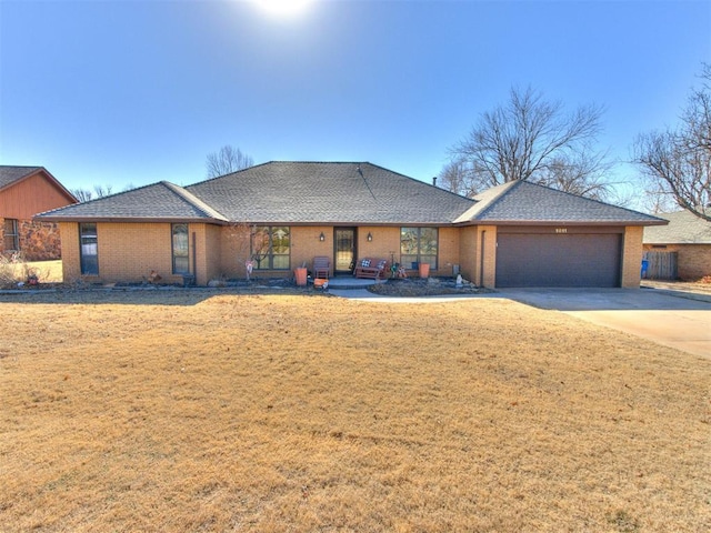 view of front of home featuring a garage and a front lawn