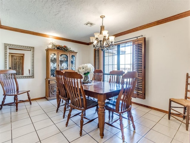 dining room featuring a chandelier, ornamental molding, a textured ceiling, and light tile patterned flooring