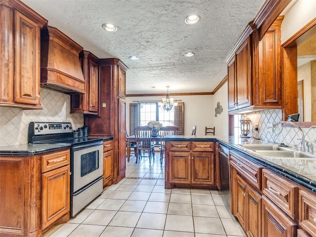 kitchen with pendant lighting, sink, premium range hood, ornamental molding, and stainless steel appliances