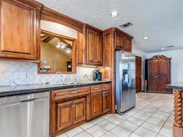 kitchen featuring sink, ceiling fan, light tile patterned floors, and appliances with stainless steel finishes