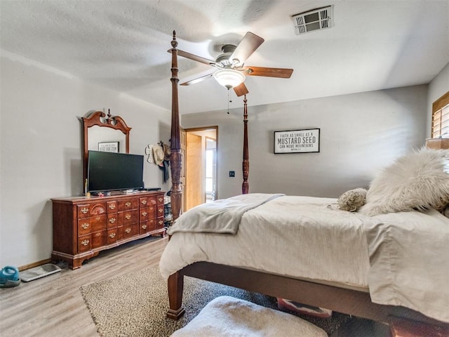 bedroom with multiple windows, light hardwood / wood-style flooring, and ceiling fan