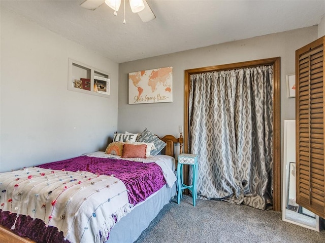 bedroom featuring ceiling fan and carpet