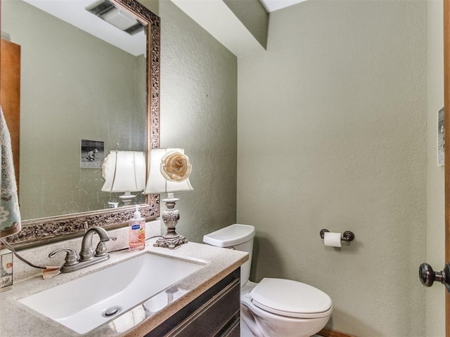 bathroom featuring toilet and vanity