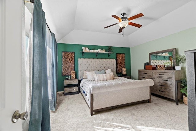 bedroom featuring light carpet, lofted ceiling, and ceiling fan