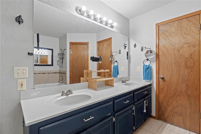 bathroom with tile patterned floors and vanity