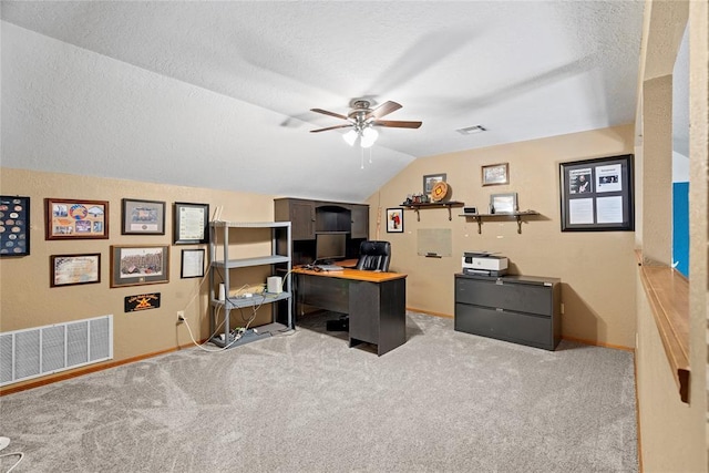 carpeted office with ceiling fan, lofted ceiling, and a textured ceiling