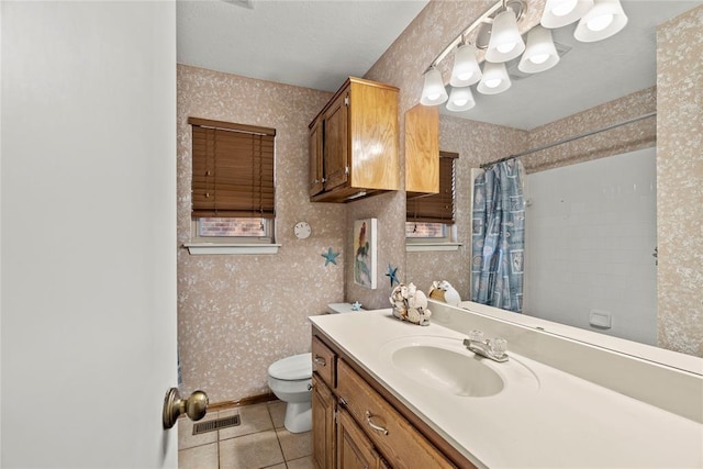 bathroom featuring a shower with curtain, tile patterned floors, toilet, and vanity