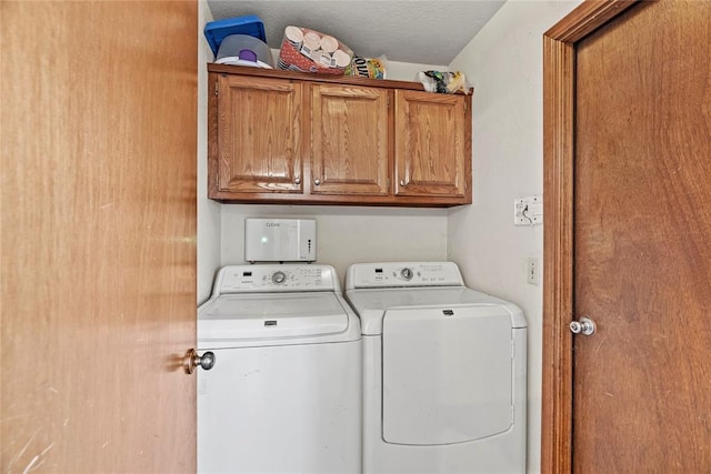 laundry room featuring cabinets and washing machine and clothes dryer