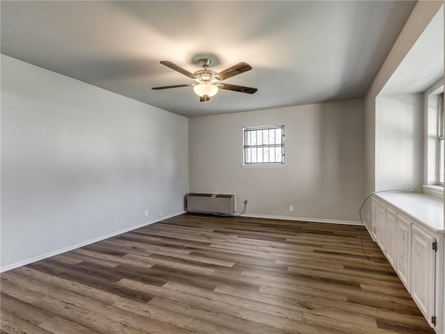 unfurnished room with ceiling fan and dark hardwood / wood-style floors