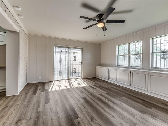 unfurnished room with ceiling fan, a wealth of natural light, and light hardwood / wood-style flooring