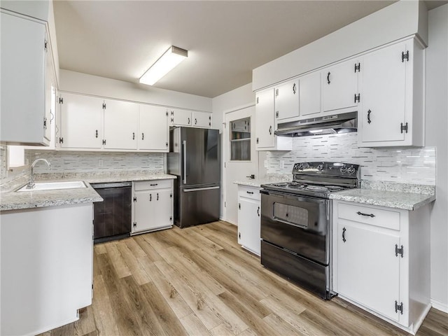 kitchen with sink, light hardwood / wood-style flooring, white cabinets, and black appliances