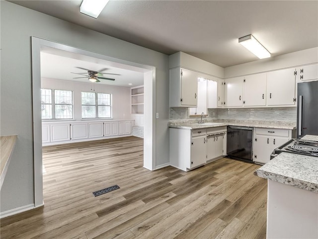 kitchen with light hardwood / wood-style floors, high end fridge, black dishwasher, electric range, and white cabinets