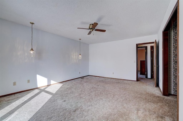 unfurnished room featuring carpet floors, a textured ceiling, and ceiling fan