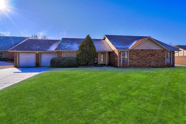 ranch-style home featuring a garage and a front lawn