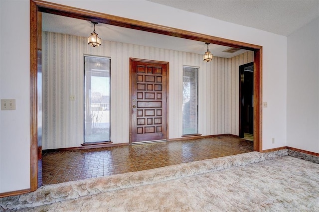 unfurnished room featuring a textured ceiling