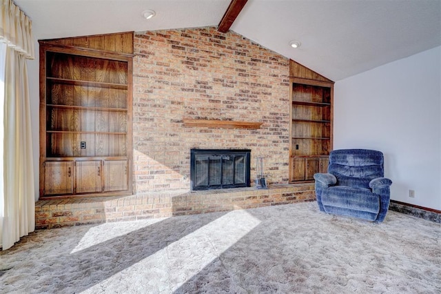 living room featuring lofted ceiling with beams, a brick fireplace, carpet floors, and built in features