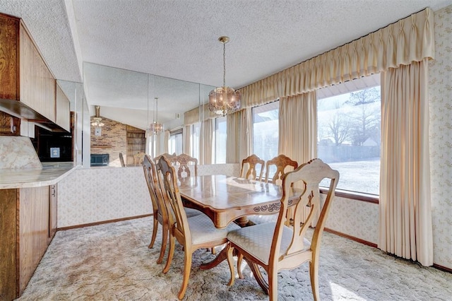 carpeted dining space with vaulted ceiling, a textured ceiling, and a notable chandelier