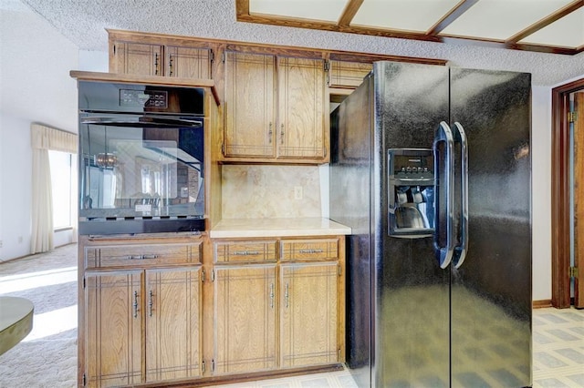 kitchen featuring decorative backsplash and black fridge