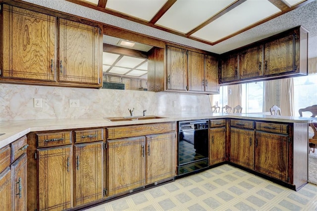 kitchen with black dishwasher, sink, and backsplash