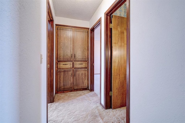 hallway featuring a textured ceiling