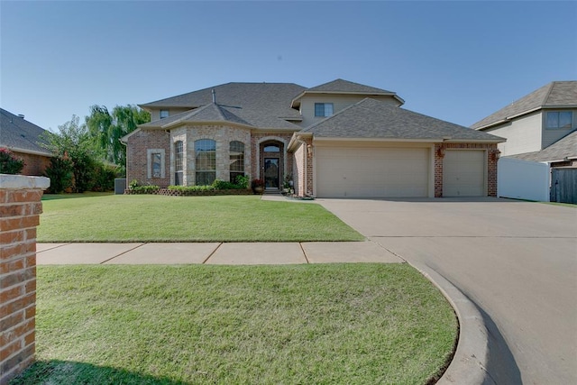 view of front of home with a front yard and a garage